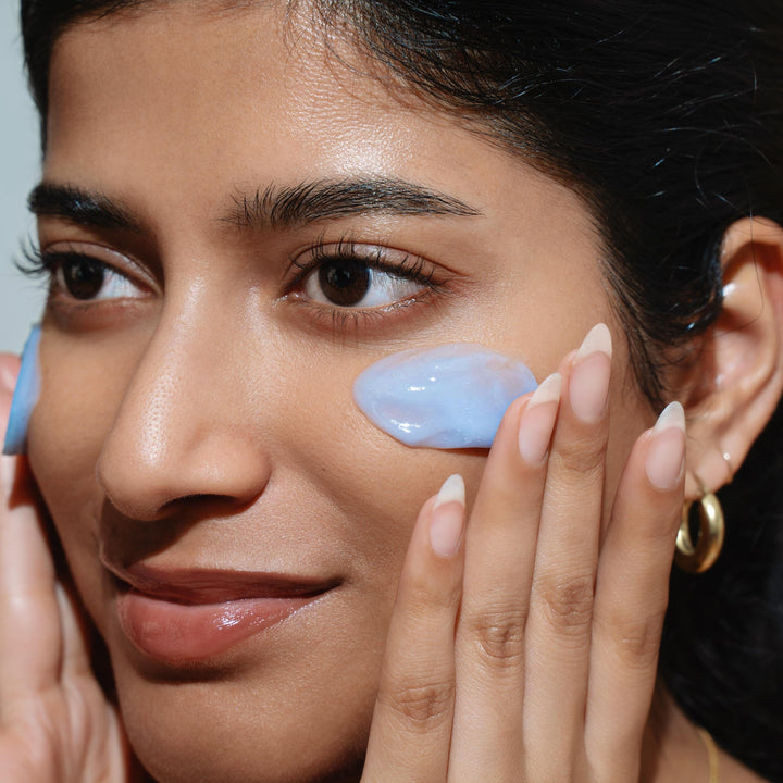 Image of a woman applying booni doon's HARMONY Hydrating Gel Moisturizer