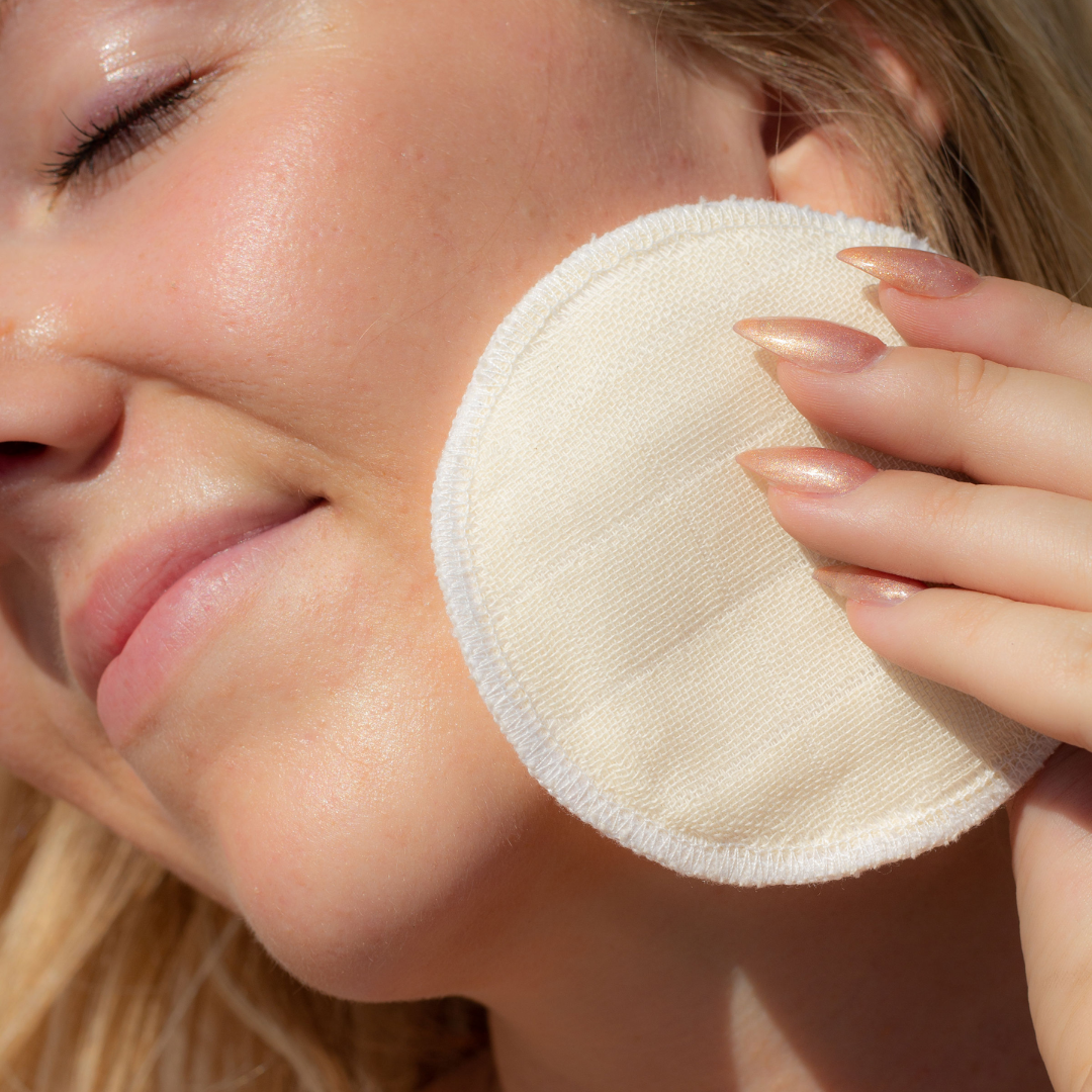 Image of woman holding booni doon PLUSH rounds to her face