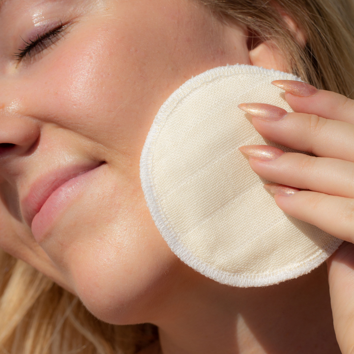 Image of woman holding booni doon PLUSH rounds to her face